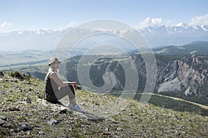 Woman Sitting On Mountain Top And Enjoying Valley View.