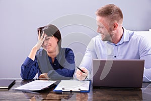 Woman Sitting New Annoying Male Colleague At Work In Office photo