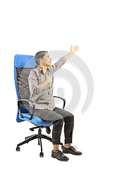 Woman sitting on the office chair and doing exercises