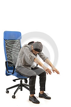Woman sitting on the office chair and doing stretching moves