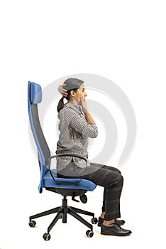 Woman sitting on the office chair and moving her head