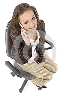 Woman sitting on the office chair - talking to the mobile phone