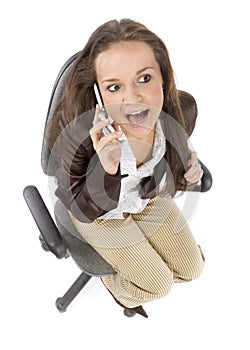 Woman sitting on the office chair - talking to the mobile phone