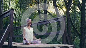 Woman sitting on the old bridge