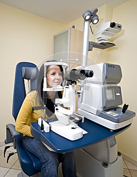 Woman sitting in optician machine