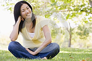 Woman sitting outdoors smiling