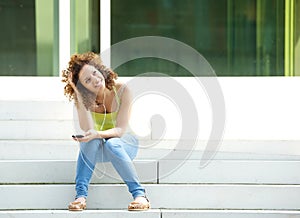 Woman sitting outside with earphones