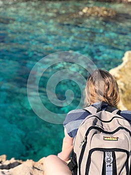 Woman Sitting over the sea in Cyprus