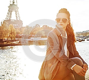 Woman sitting on the parapet and looking into distance in Paris