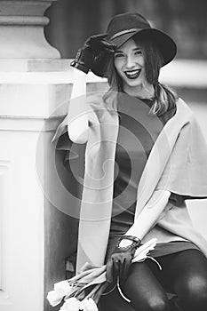 Woman sitting on the park background with flowers