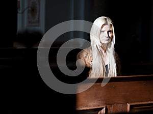 Woman sitting on a Pew photo