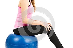 Woman sitting on pilates ball