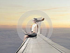 Woman sitting on a plane wing