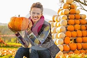Woman sitting with pumpkin