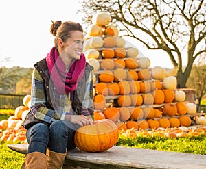 Woman sitting with pumpkin