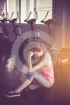 Woman sitting and relax after the training session,Concept healthy and lifestyle,Female tired with taking a break after exercise a