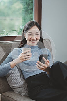 Woman is sitting and relaxing on the sofa, Sitting comfortably on the sofa, Relax in the living room at home on holiday, Live a