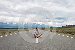 Woman sitting on the road