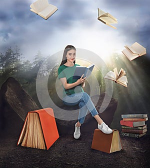 Woman sitting on rock and flying books in forest