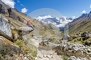 Woman sitting on a rock during the Salkantay trek