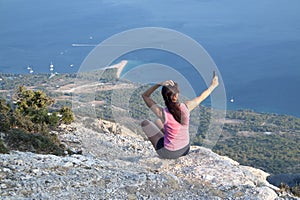 Woman sitting on the rocks of Vidova Gora, the mountain of Saint Vid, BraÄ island in Croatia, Mediterrane