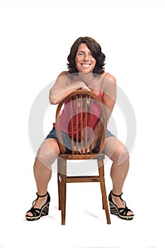 Woman sitting on a rotated chair and looking at camera