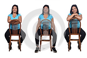 Woman sitting with rotated chair on white background