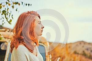 Woman sitting on rusty old classic truck.