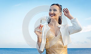 Woman sitting by the sea at a party on beach