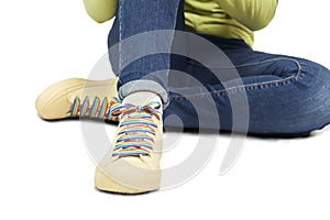 Woman sitting with slippers with laces with rainbow gay LGBT flag
