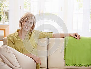 Woman sitting on sofa at home