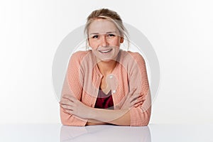 Woman sitting in sparse office expressing wellbeing at work