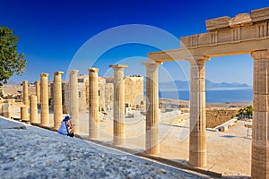 Woman sitting on Staircase of the Propylaea on the Acropolis of