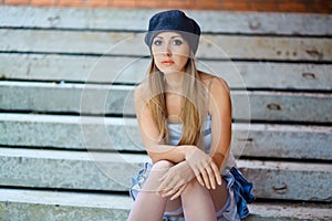 Woman sitting on a step of abandoned building