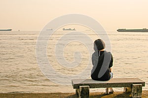 Woman sitting on a stone bench