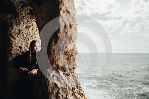 Woman sitting on the stone. Travel concept