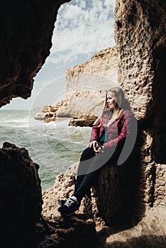 Woman sitting on the stone. Travel concept