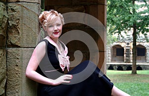 Woman Sitting on Stone Wall