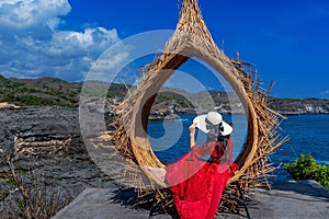 Woman sitting on straw nests in Bali island, Indonesia. photo