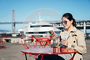 Woman sitting on street cafe outdoor near port