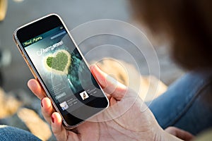 woman sitting in the street holding her smartphone honeymoon