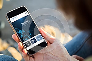 woman sitting in the street holding her smartphone with innovative interface