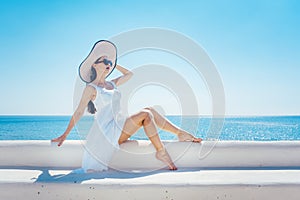 Woman sitting in the sun on a greek beach