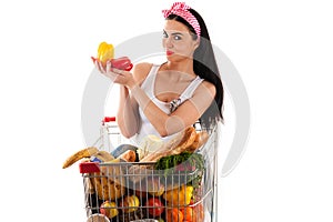 Woman sitting in supermarket trolley