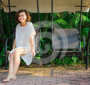 Woman sitting in swingset photo