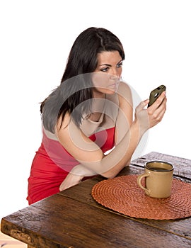 Woman sitting at table on cell phone