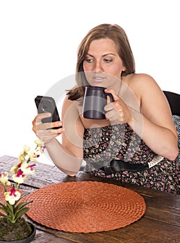 Woman sitting at table on cell phone