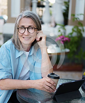 Woman Sitting at Table With Coffee Cup