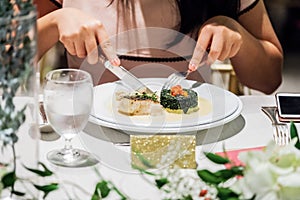 Woman sitting at table and having nice dinner