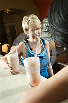 Woman sitting at table in health club.